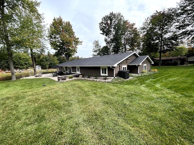 view of front of house featuring a patio area, central AC, and a front lawn