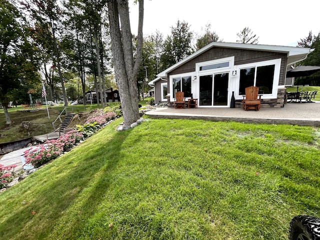 1571 Loebrich Dr, Gladwin, MI 48624 - view of grassy yard featuring a patio area