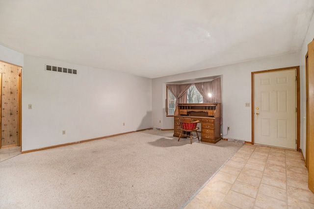 unfurnished living room with light colored carpet