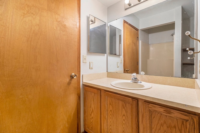 bathroom with vanity and walk in shower