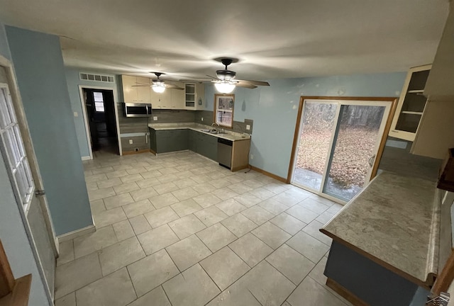 kitchen with white cabinets, a wealth of natural light, ceiling fan, and appliances with stainless steel finishes