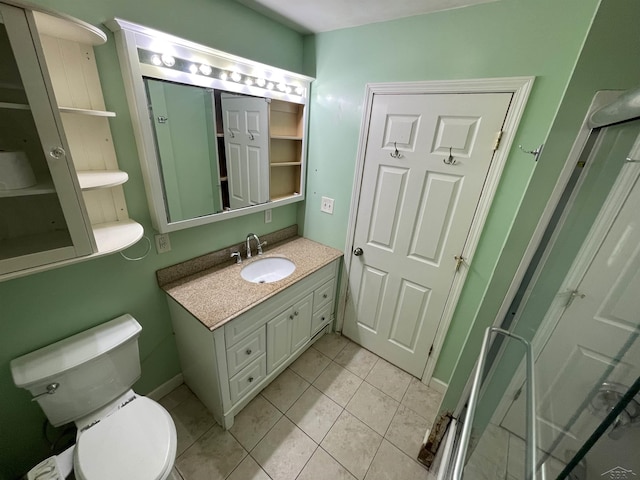 bathroom featuring tile patterned flooring, vanity, and toilet