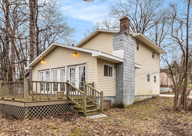 back of property with a deck and french doors