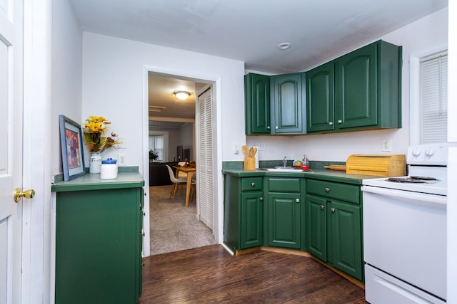 kitchen with dark hardwood / wood-style floors, white range with electric cooktop, green cabinetry, and sink