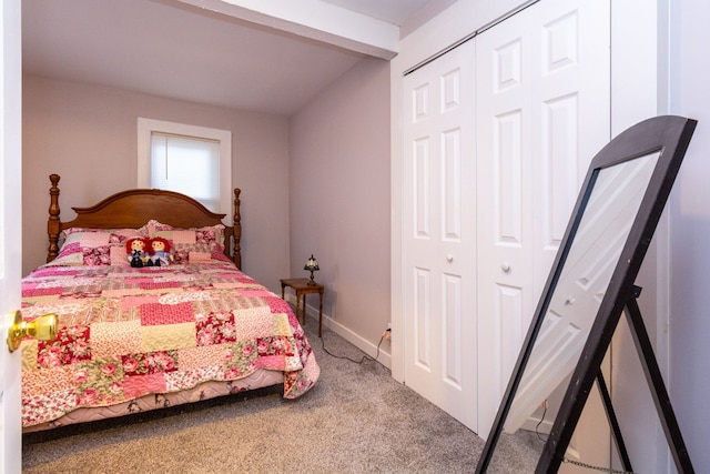 carpeted bedroom with beamed ceiling and a closet