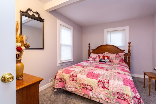 bedroom with beam ceiling and carpet floors