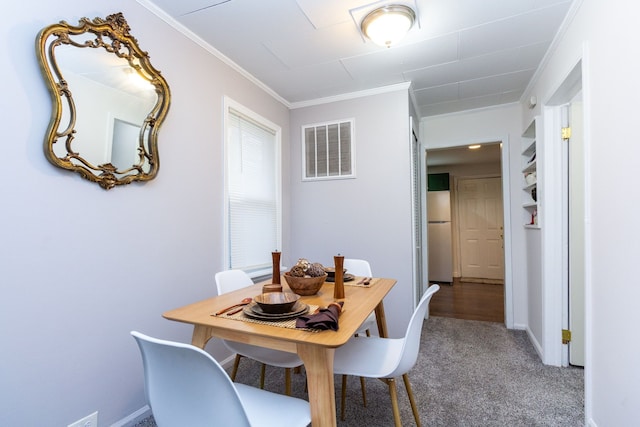 dining room with carpet floors and ornamental molding