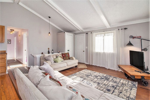 living room featuring vaulted ceiling with beams, wood-type flooring, and a textured ceiling