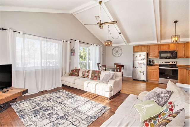 living room with hardwood / wood-style flooring, ceiling fan with notable chandelier, beamed ceiling, and high vaulted ceiling