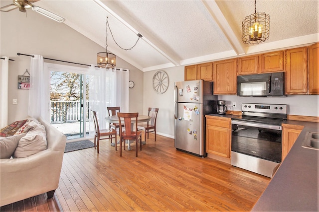 kitchen featuring lofted ceiling with beams, light hardwood / wood-style floors, stainless steel appliances, and hanging light fixtures