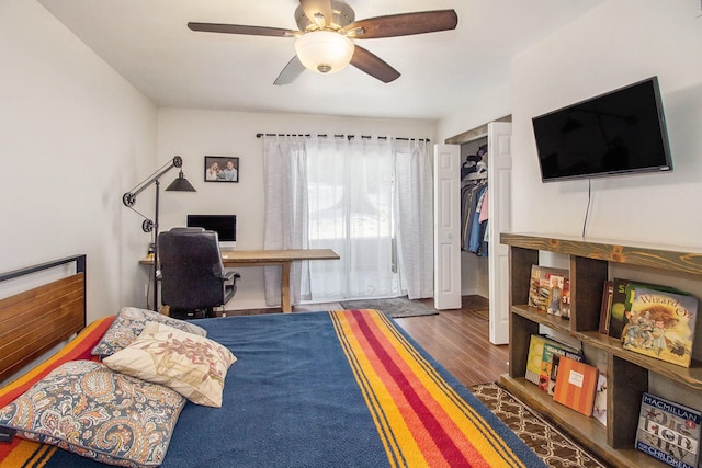 bedroom featuring ceiling fan, a closet, and dark hardwood / wood-style floors