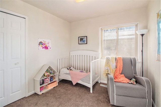 carpeted bedroom with a closet and a nursery area