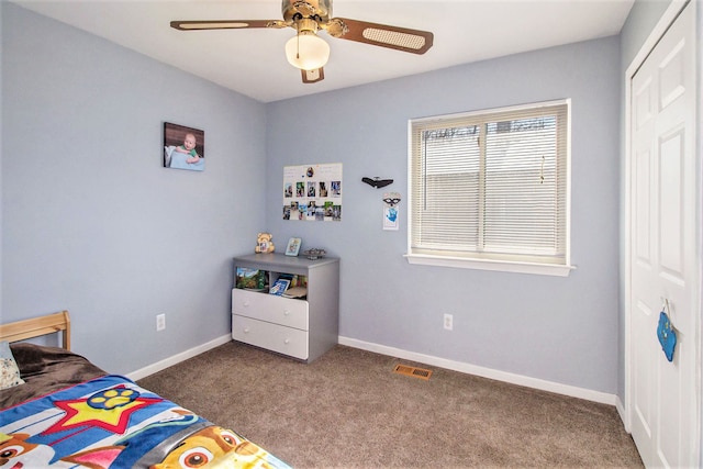 bedroom with carpet, ceiling fan, and a closet