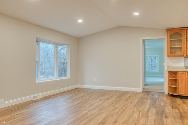 interior space with light hardwood / wood-style floors and vaulted ceiling