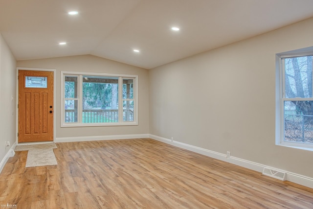 entryway featuring vaulted ceiling and light hardwood / wood-style flooring