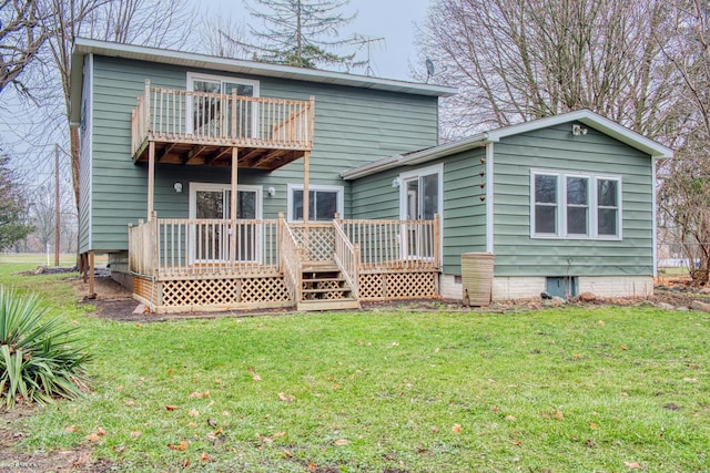 rear view of property featuring a lawn and a balcony