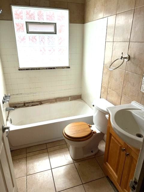 22482 W Mcnichols Rd, Detroit, MI 48219 - bathroom with vanity, tile patterned floors, tile walls, and  shower combination