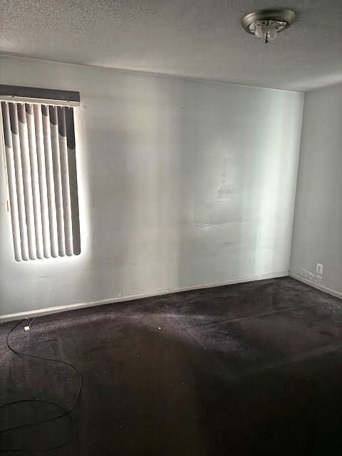 empty room featuring concrete floors and a textured ceiling