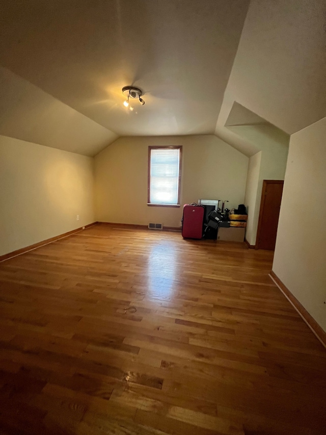 bonus room featuring wood-type flooring and lofted ceiling