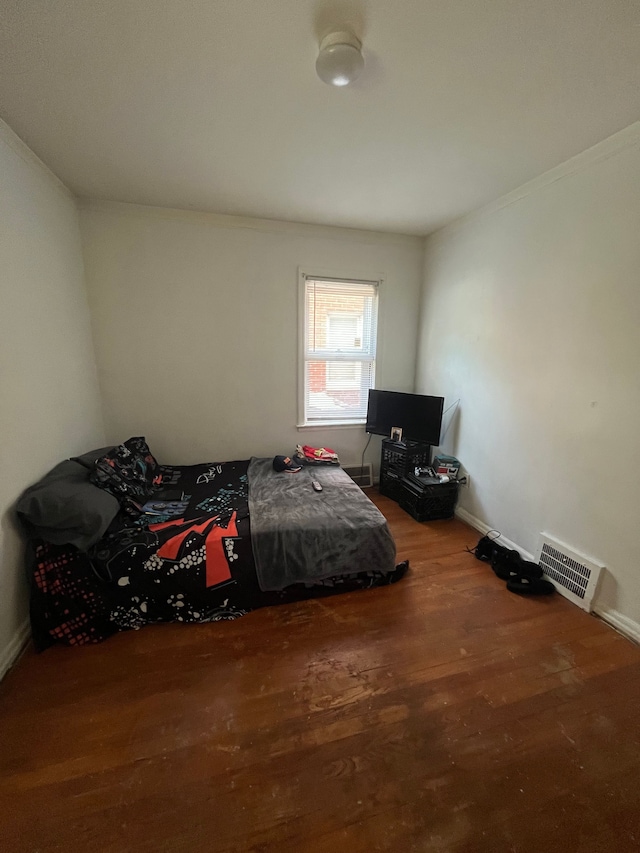 bedroom with wood-type flooring