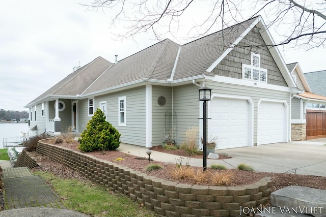 585 Crescent Dr, Holland, MI 49423 - view of front of property featuring roof with shingles, concrete driveway, and a garage
