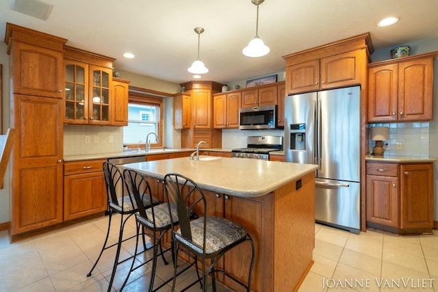 585 Crescent Dr, Holland, MI 49423 - kitchen with brown cabinets, a sink, and appliances with stainless steel finishes