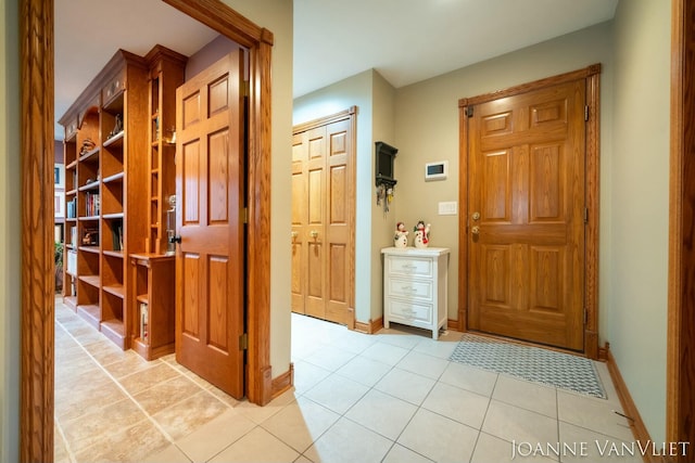 585 Crescent Dr, Holland, MI 49423 - entryway with light tile patterned flooring and baseboards