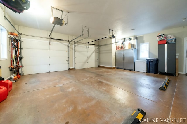 585 Crescent Dr, Holland, MI 49423 - garage with a garage door opener and freestanding refrigerator
