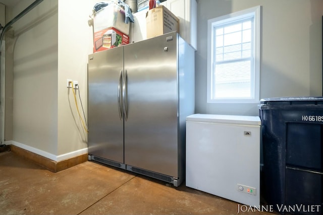 585 Crescent Dr, Holland, MI 49423 - kitchen featuring finished concrete floors, freestanding refrigerator, baseboards, and fridge