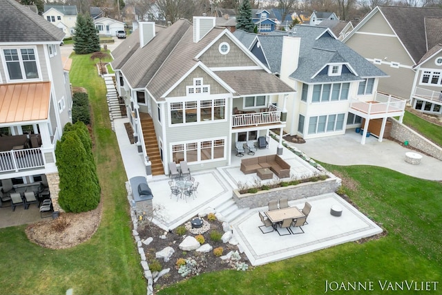 back of property with outdoor lounge area and a patio area