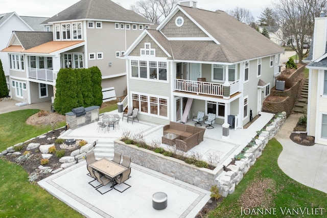 585 Crescent Dr, Holland, MI 49423 - back of property featuring outdoor dining space, a patio area, a shingled roof, and an outdoor hangout area