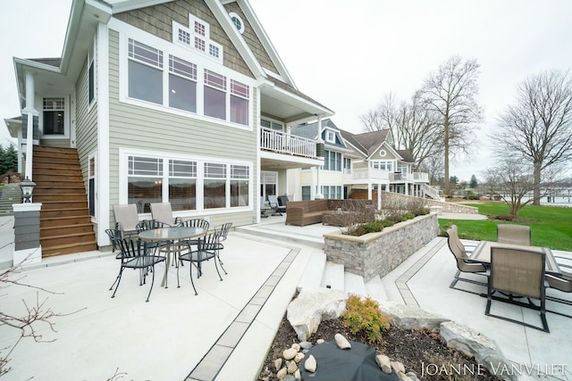 585 Crescent Dr, Holland, MI 49423 - back of house featuring outdoor dining space, an outdoor hangout area, a patio area, and stairs