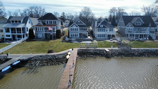 585 Crescent Dr, Holland, MI 49423 - exterior space featuring a residential view, a balcony, a water view, a yard, and fence
