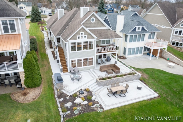 585 Crescent Dr, Holland, MI 49423 - rear view of house featuring stairway, outdoor dining space, a patio area, an outdoor living space, and a residential view