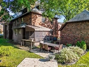 back of property featuring a patio area and a sunroom