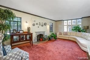 carpeted living room with ornamental molding