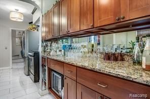 kitchen with light stone countertops, light tile patterned floors, and range