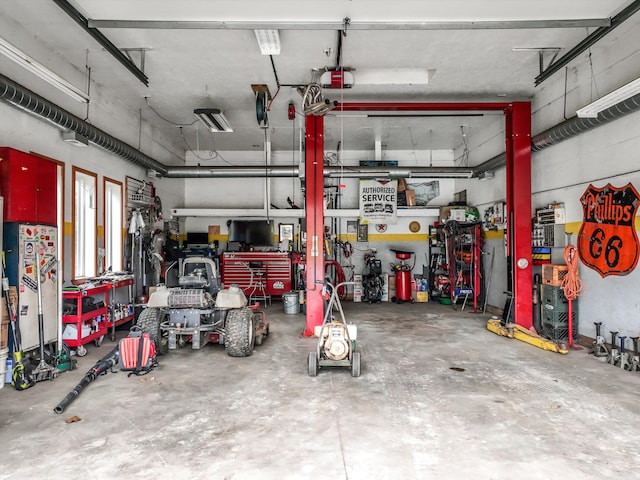 garage featuring a garage door opener and a workshop area