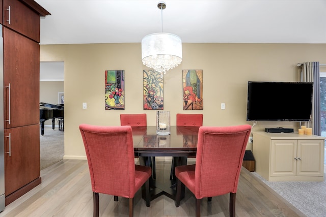 dining space featuring a chandelier and light wood-type flooring