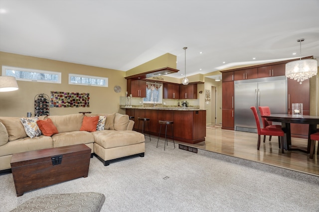 living room with sink and light colored carpet