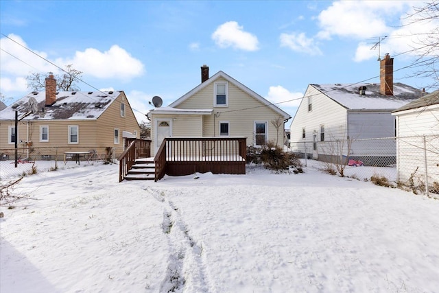 view of snow covered back of property