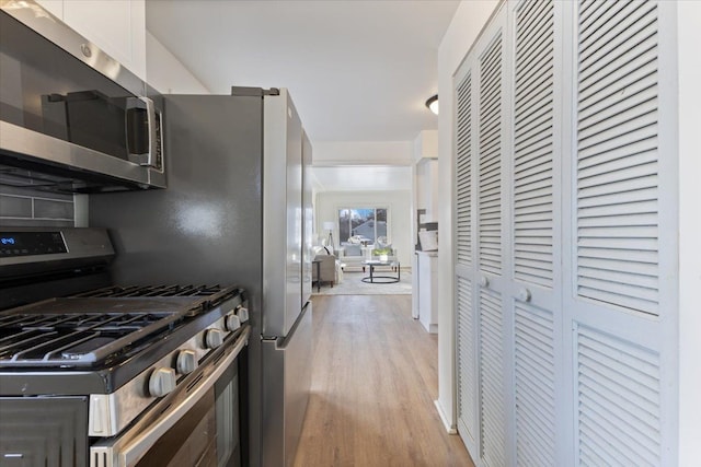 kitchen featuring white cabinetry, stainless steel appliances, and light hardwood / wood-style flooring