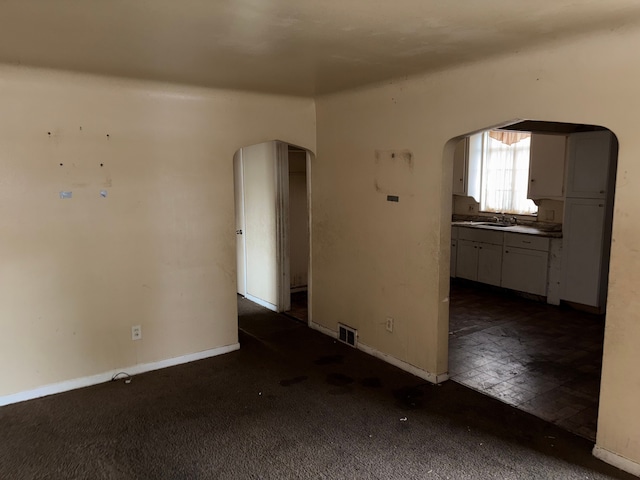 carpeted empty room featuring sink