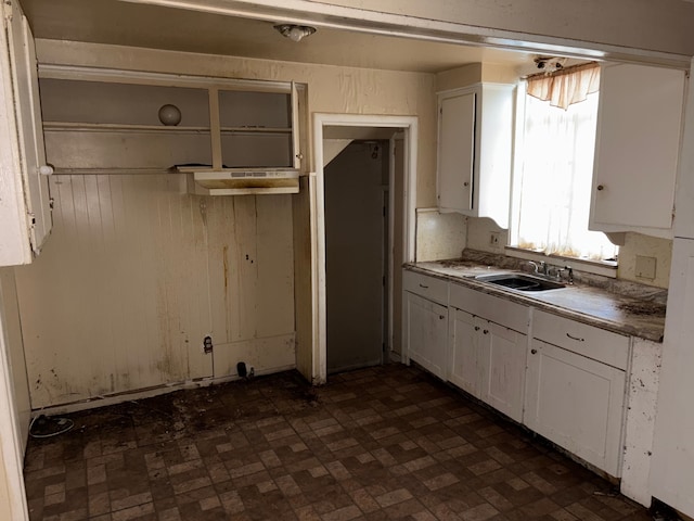 kitchen featuring white cabinetry and sink