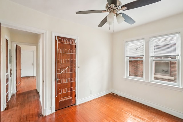 unfurnished room featuring ceiling fan and hardwood / wood-style floors