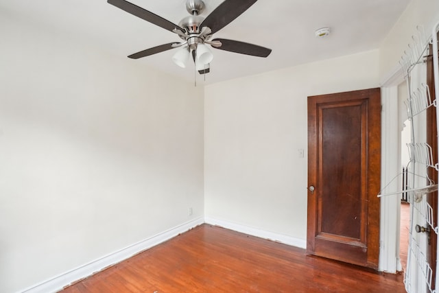 spare room featuring ceiling fan and dark wood-type flooring