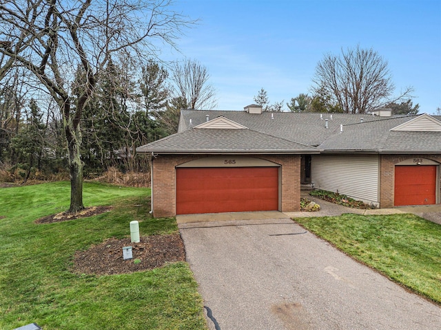 view of front of property featuring a garage and a front lawn