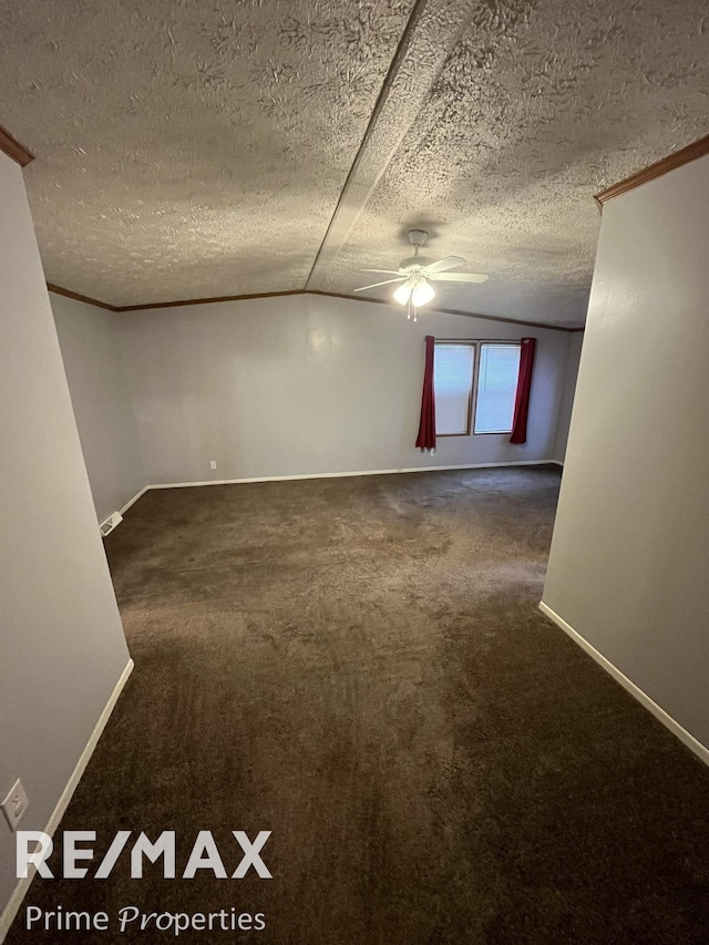 carpeted spare room featuring ceiling fan, lofted ceiling, a textured ceiling, and ornamental molding