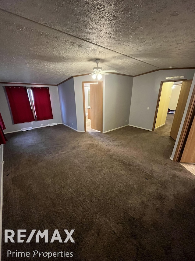 carpeted empty room with ornamental molding, ceiling fan, and a textured ceiling