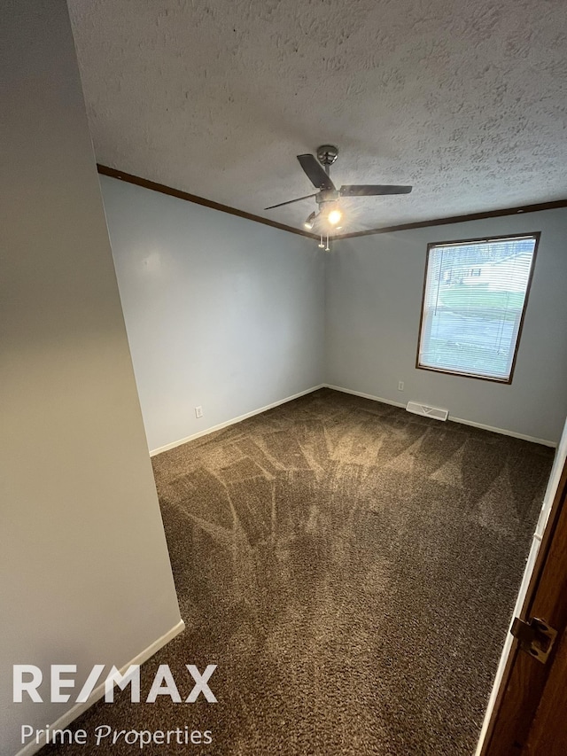 carpeted empty room with ceiling fan, crown molding, and a textured ceiling